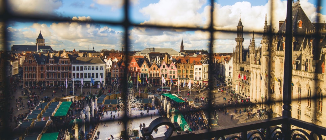 Aerial view of Bruges, Belgium city center, shot through bars of an upper terrace fence.