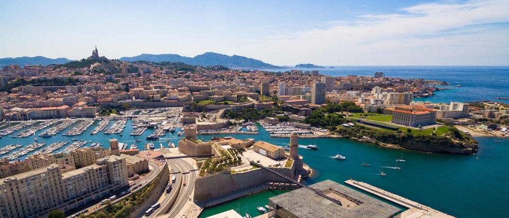 Aerial view of Marseille, France during the day. Boats flow through the waterways