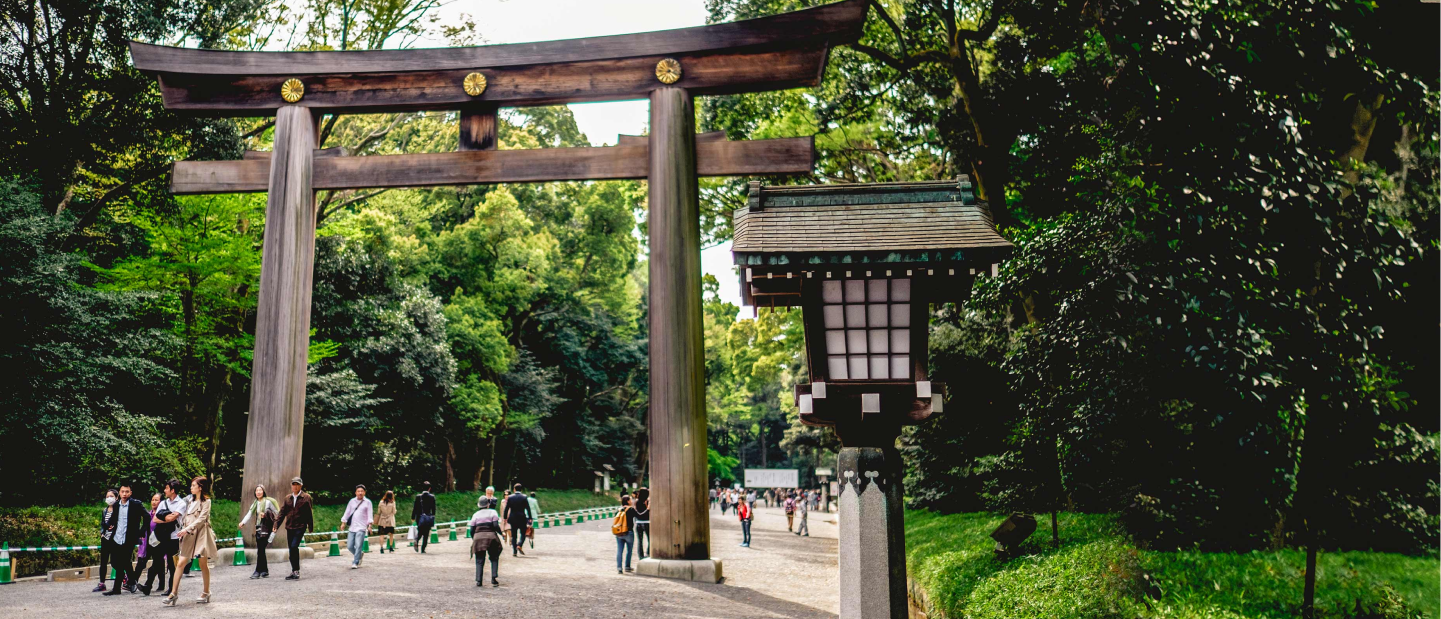 Just outside the Shinjuku Gyo-en Japanese National Garden in Tokyo. People are walking through a massive wooden arch way.