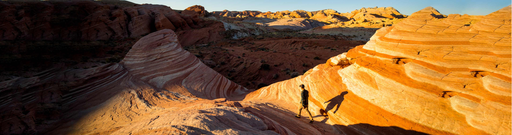 The Red Rock Canyon basin near Las Vegas, Nevada. A man is walking along the top of a ridge.