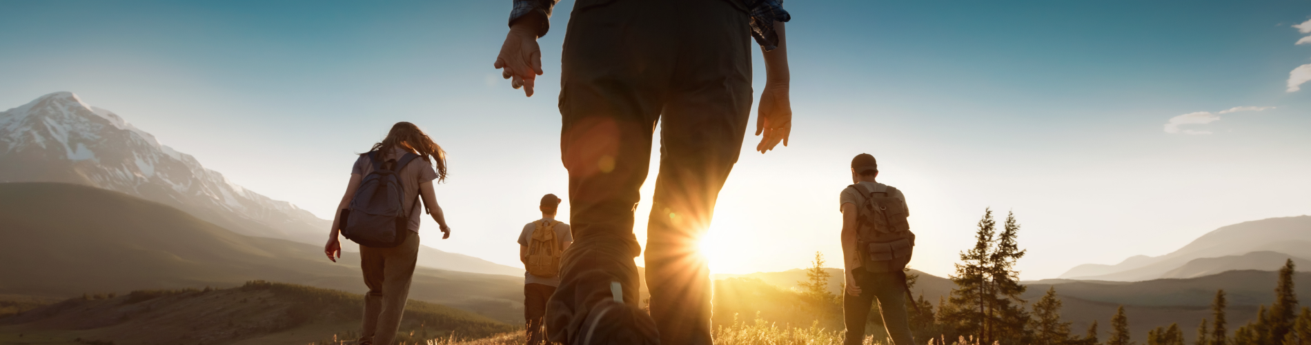A group of friends hiking in the mountains at dawn.