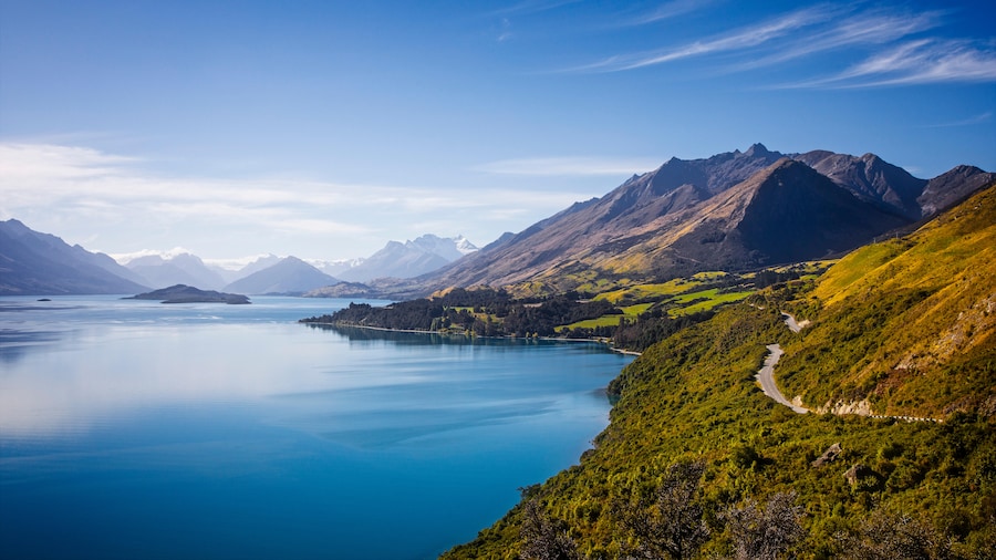 sunny mountain landscape with lake on the left