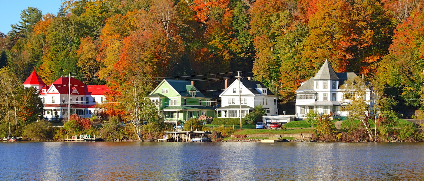The view from a room of a brick-clad hotel room, looking out over a palm-fringed beach with a skate park in the centre.