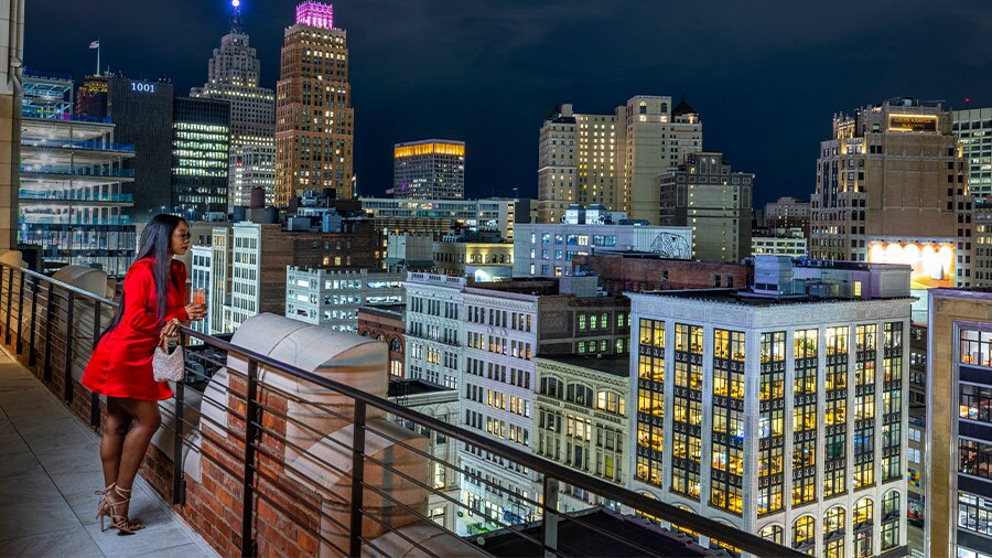 Customer of Monarch Club on a balcony overlooking downtown Detroit, Michigan