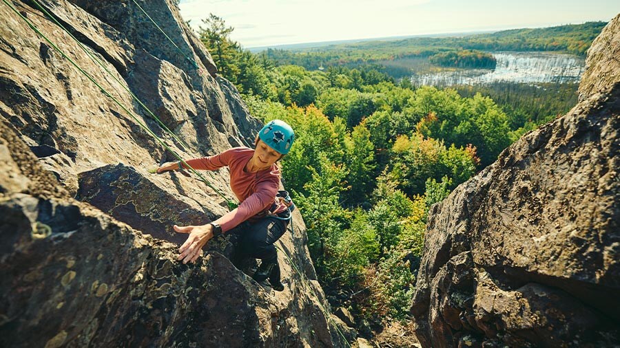 Rock climber on a crag near Marquette, Michigan