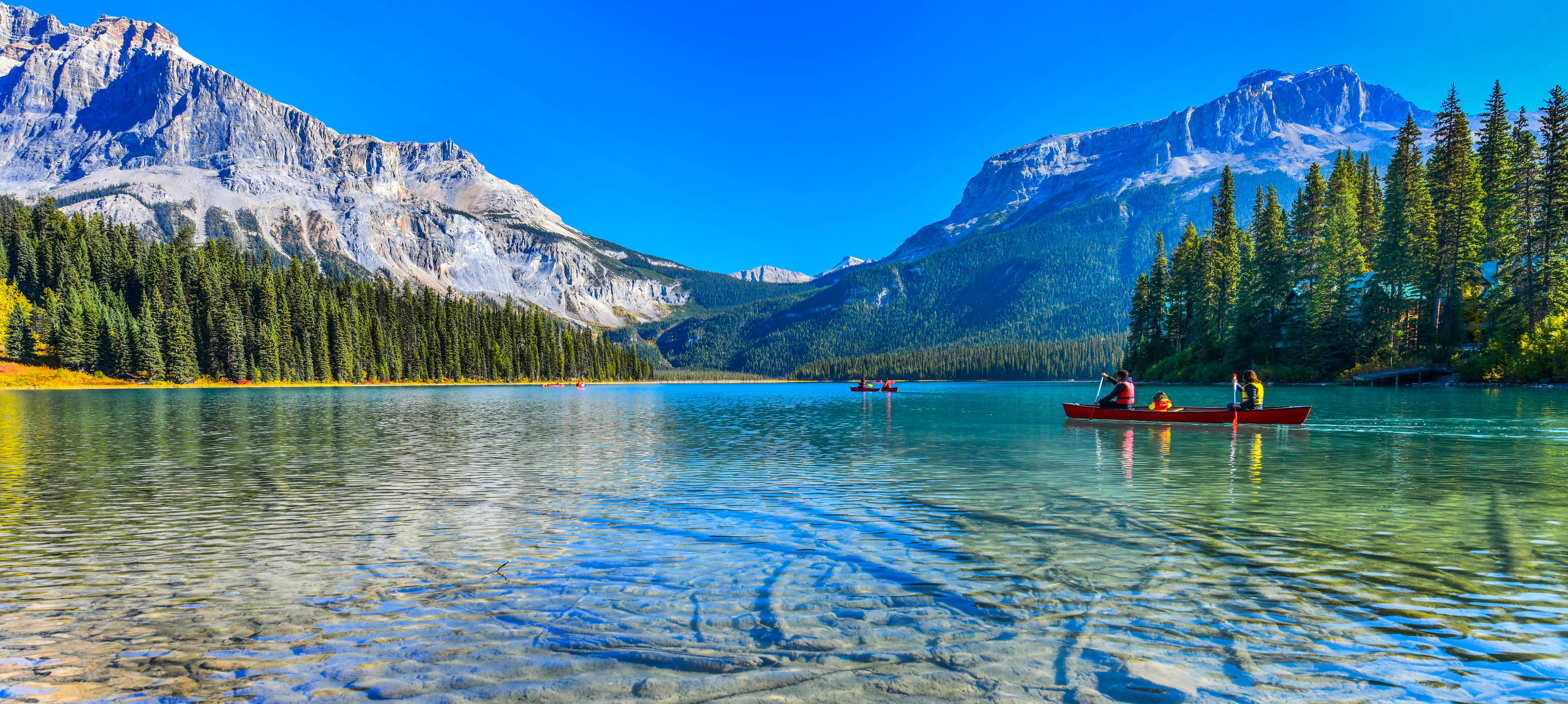 Looking out on a lake with a family kayaking in the background