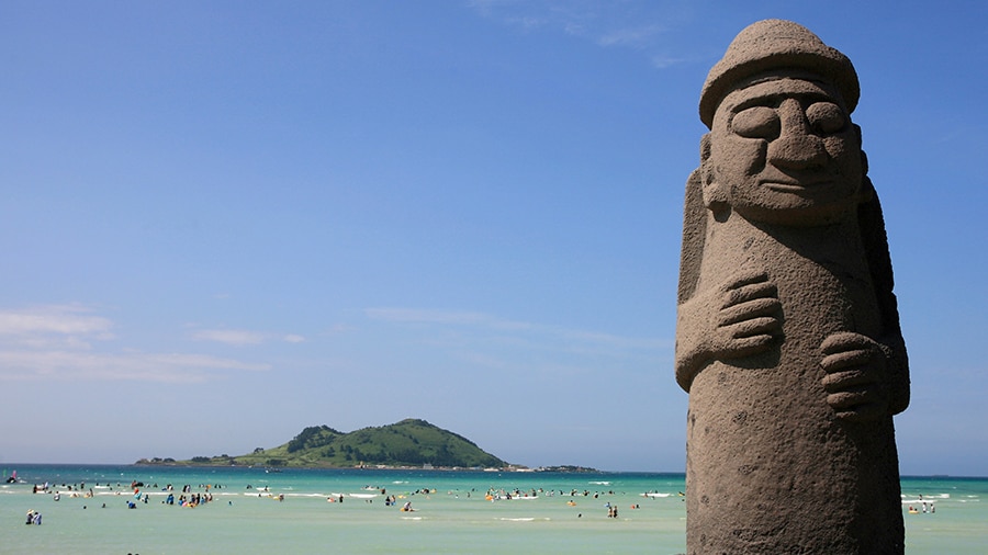 A stone statue on a beach