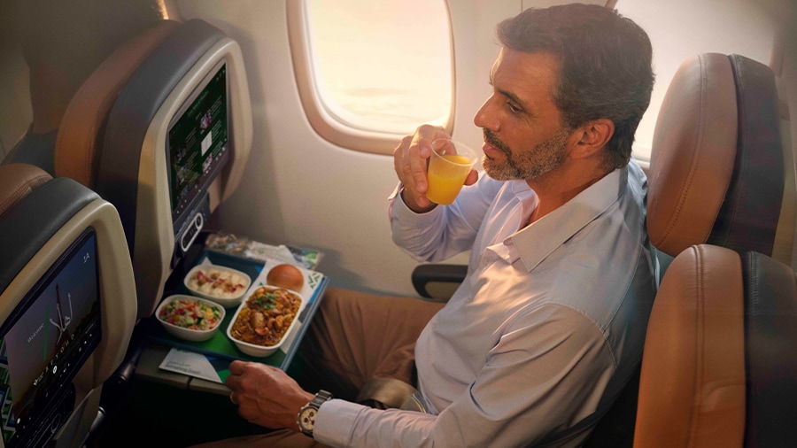 A person eating food on an airplane