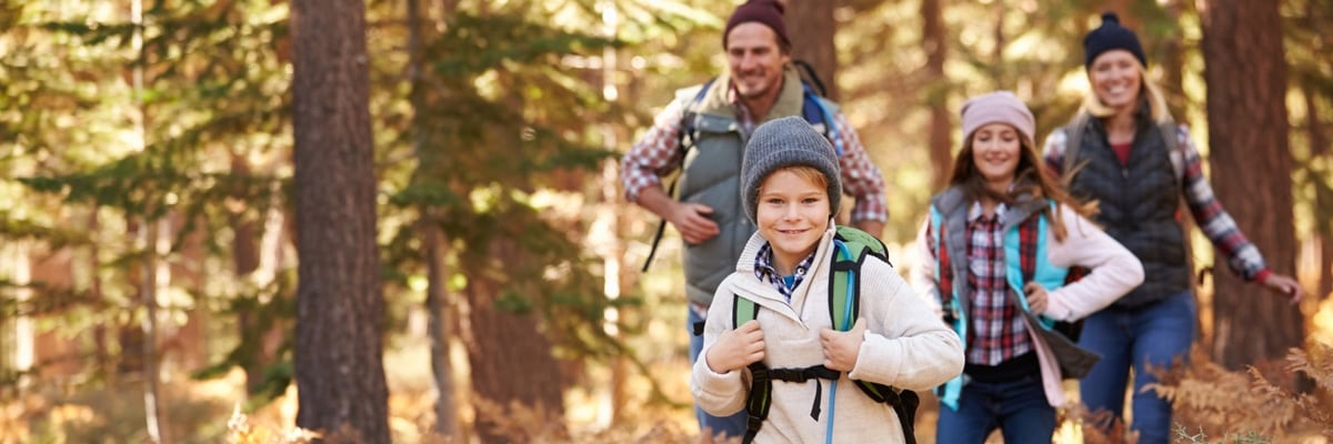 A family on a hike in the woods.