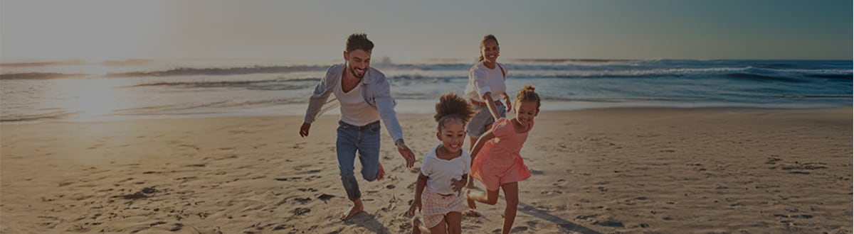 Family running on a beach