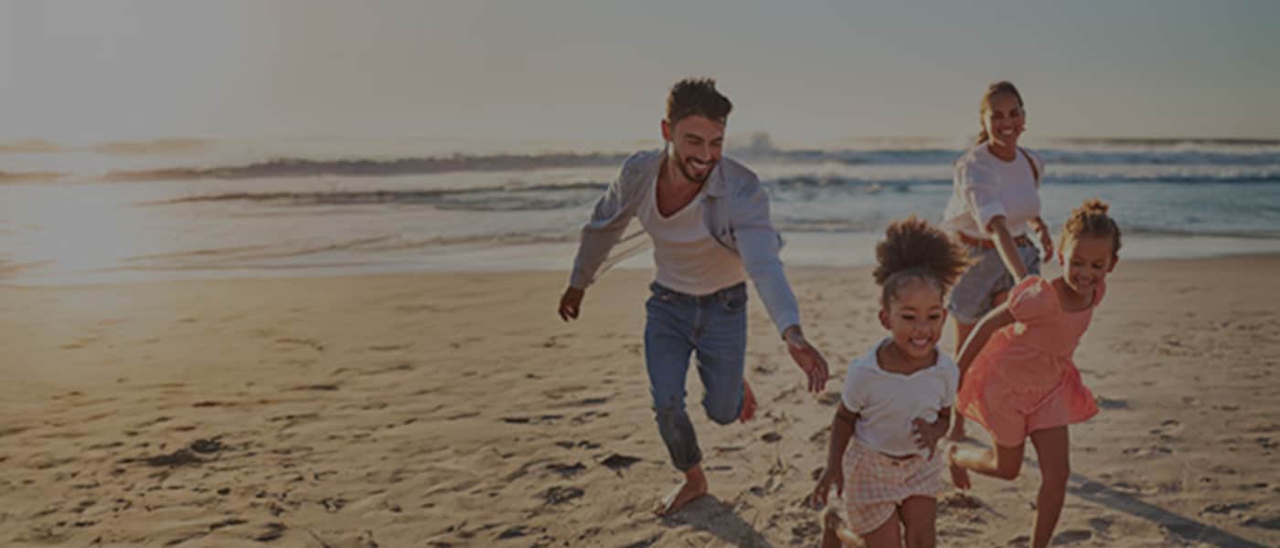 Family running on a beach