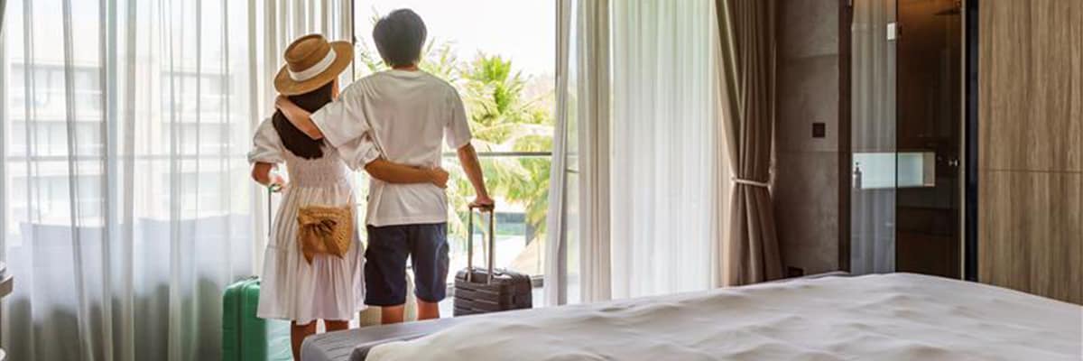 Couple looking out the window in a hotel room