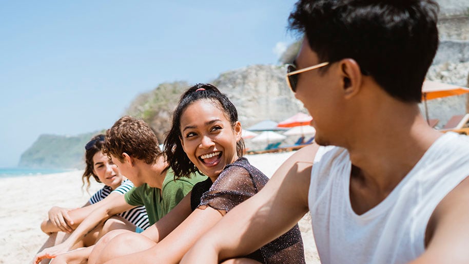 Group of friends sitting on a beach