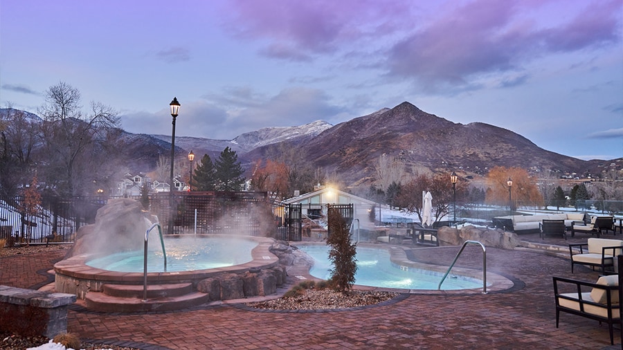 A hot springs with a mountain in the background