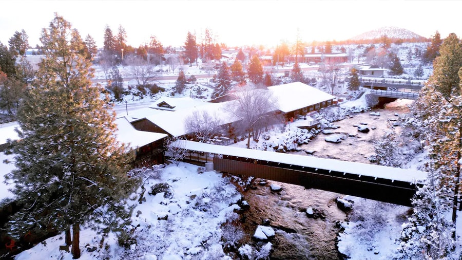 A bridge over a river with snow