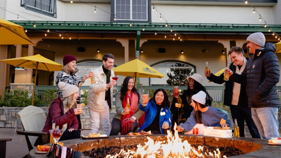 A group of people sitting around a fire pit