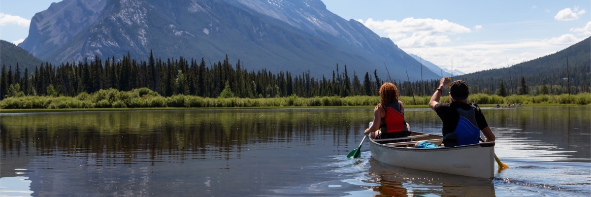 A couple in a canoe in Vermilion Lakes in Banff National Park, Alberta, Canada.