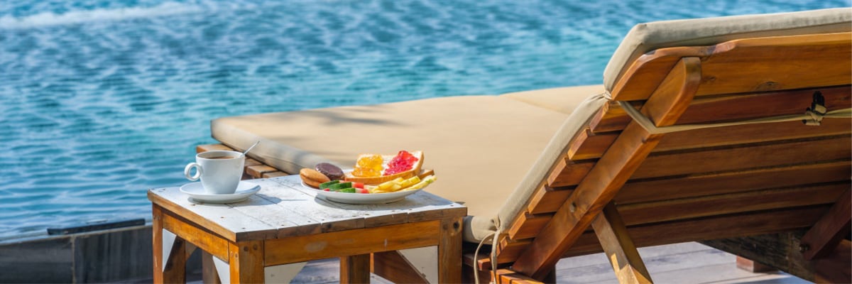 Fruit, tea and lounge chair by pool