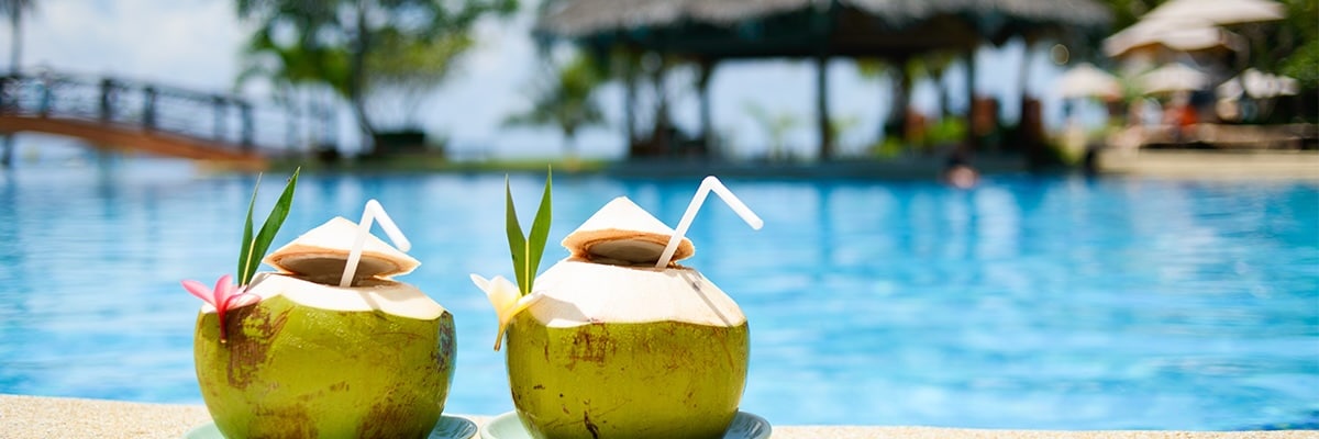 Tropical green coconut beverages served poolside.