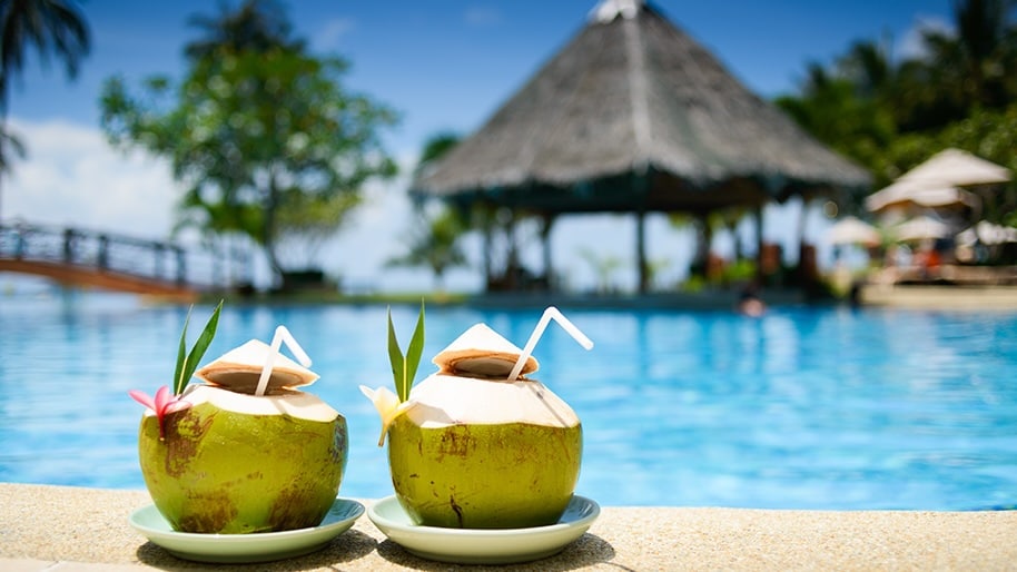 Tropical green coconut beverages served poolside.