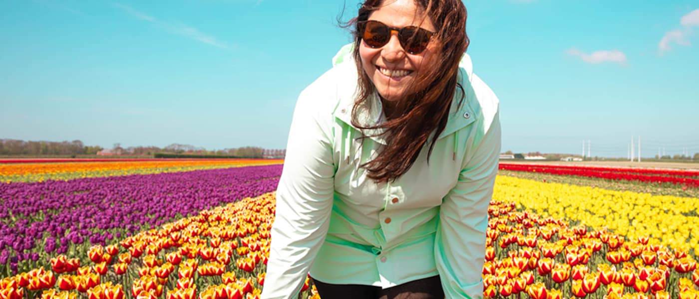 Woman in a field of colourful tulips