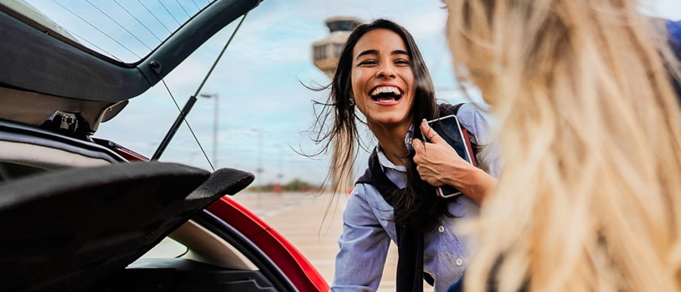Two friends pick up their Hertz car rental.