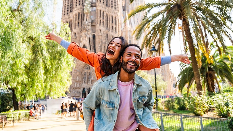 A couple in front of the Sagrada Familia cathedral in Barcelona, Spain