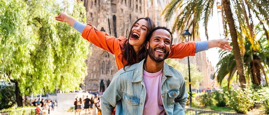 A couple in front of the Sagrada Familia cathedral in Barcelona, Spain