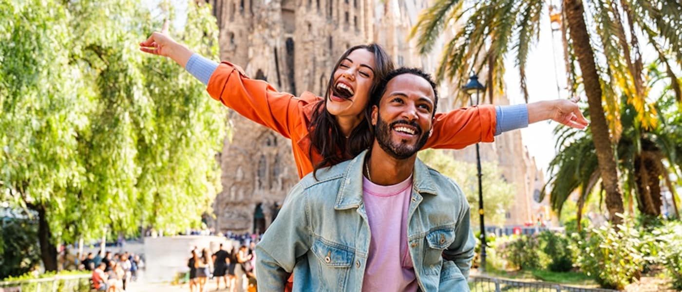 A couple in front of the Sagrada Familia cathedral in Barcelona, Spain
