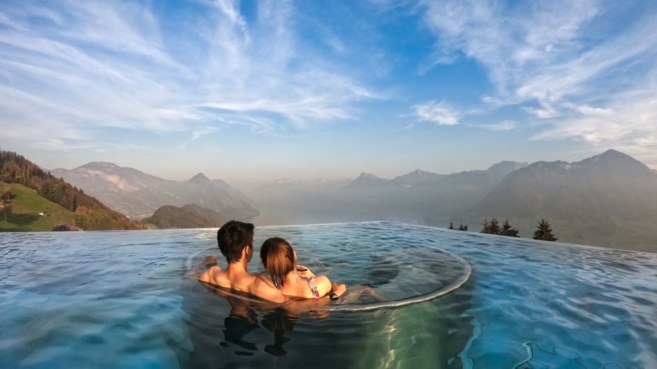 Couple at the pool looking at the mountains.