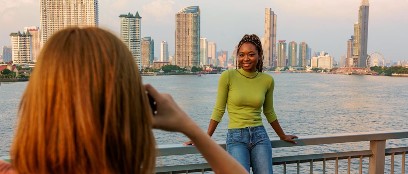 A woman takes a photograph along the Asiatique The Riverfront.
